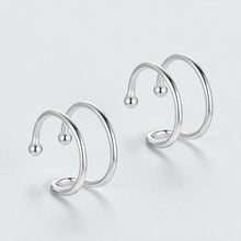 Pair of 925 sterling silver double loop ear cuffs displayed on light background showing minimalist non pierced hypoallergenic hoop design
