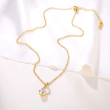 Trendy layered jewelry look featuring 18K gold plated CZ pendant chain necklace.