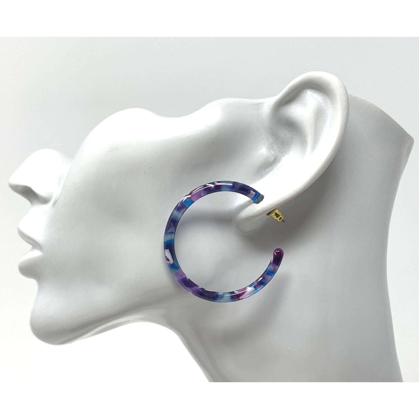 A pair of statement resin hoop earrings with a bold and eye-catching design