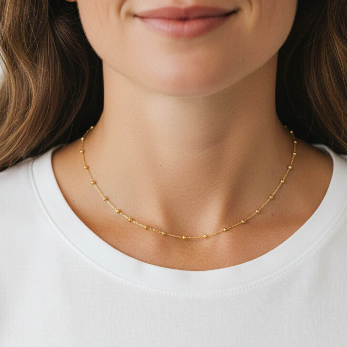 Delicate 14-16 inch 18K gold plated bead necklace in 925 sterling silver worn by model.