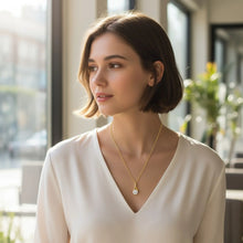 Model wearing 18K gold plated cubic zirconia pendant necklace showing elegant sparkle and adjustable fit
