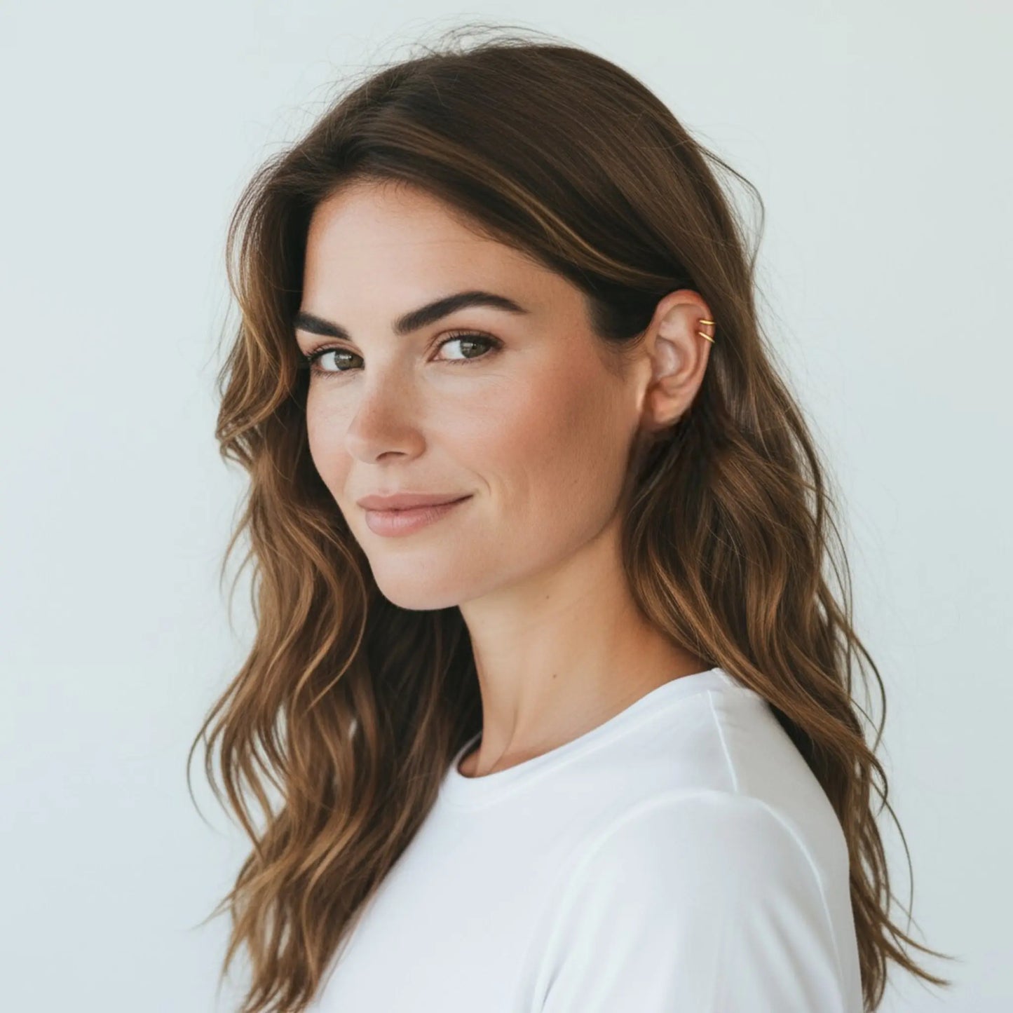 Model wearing 18K gold plated double loop ear cuffs showing elegant minimalist non-pierced hoop earrings style for women