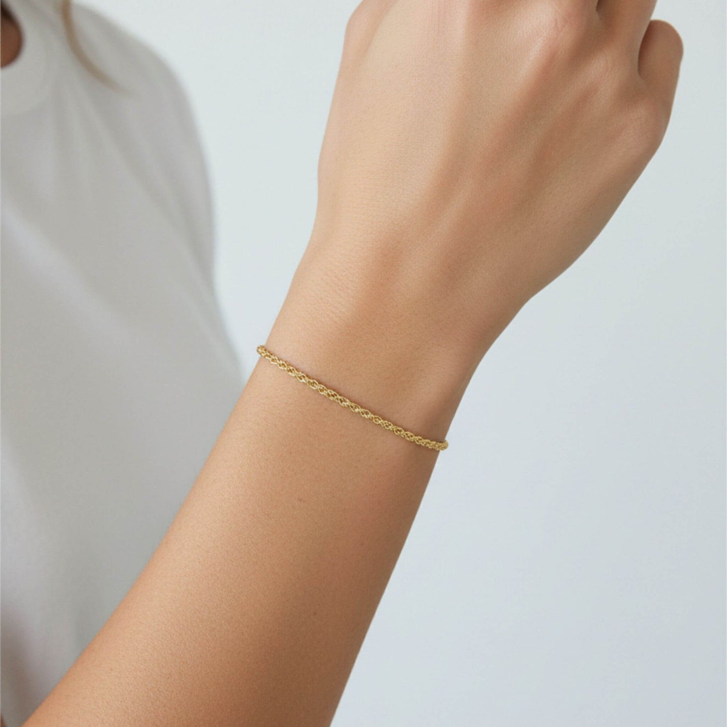 Minimalist 18K gold plated rope chain bracelet worn on wrist for everyday wear