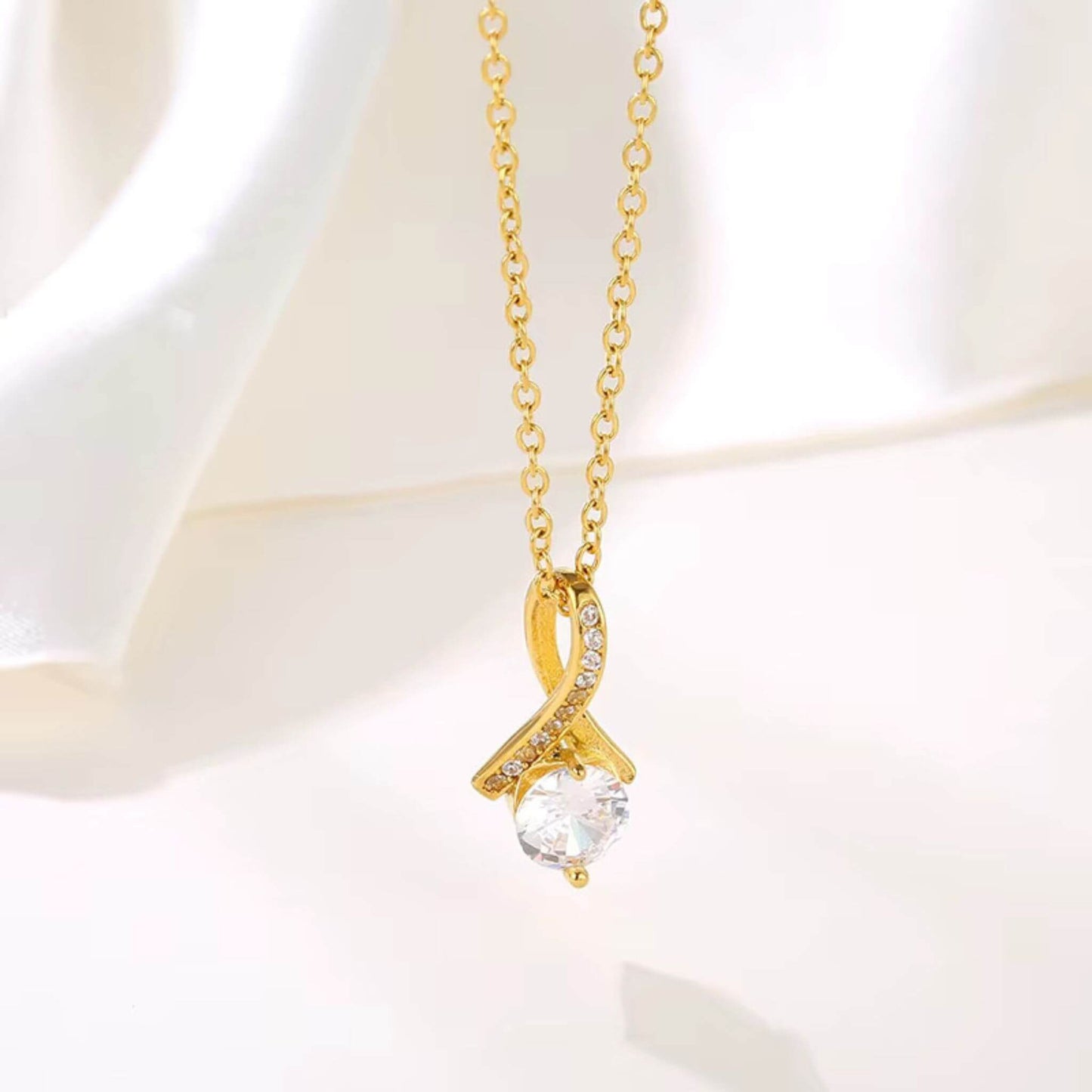 Close-up of 7mm round cubic zirconia stone on 18K gold plated pendant - brilliant diamond-like sparkle.