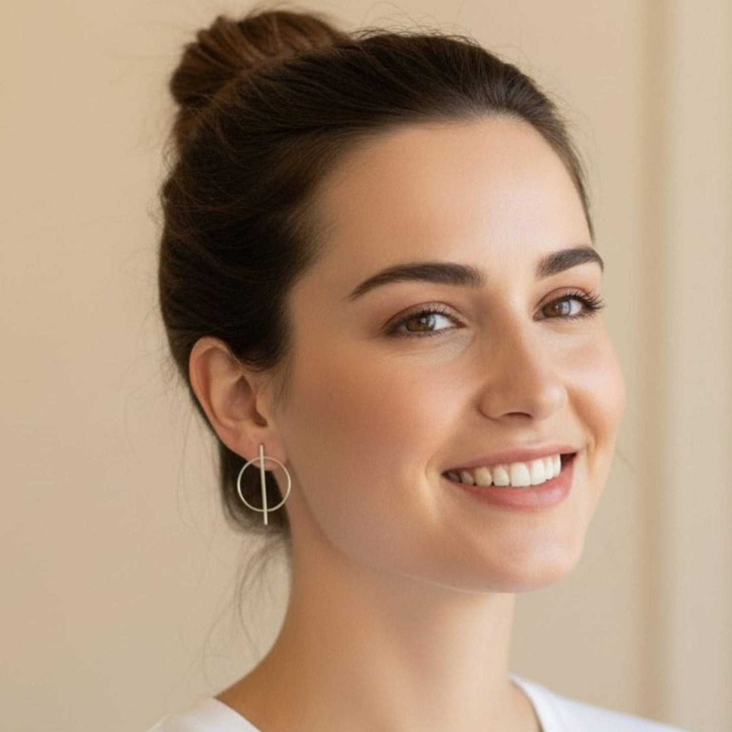 Close-up of 925 sterling silver open circle and vertical bar stud earring on model's ear, showing polished silver finish and geometric design
