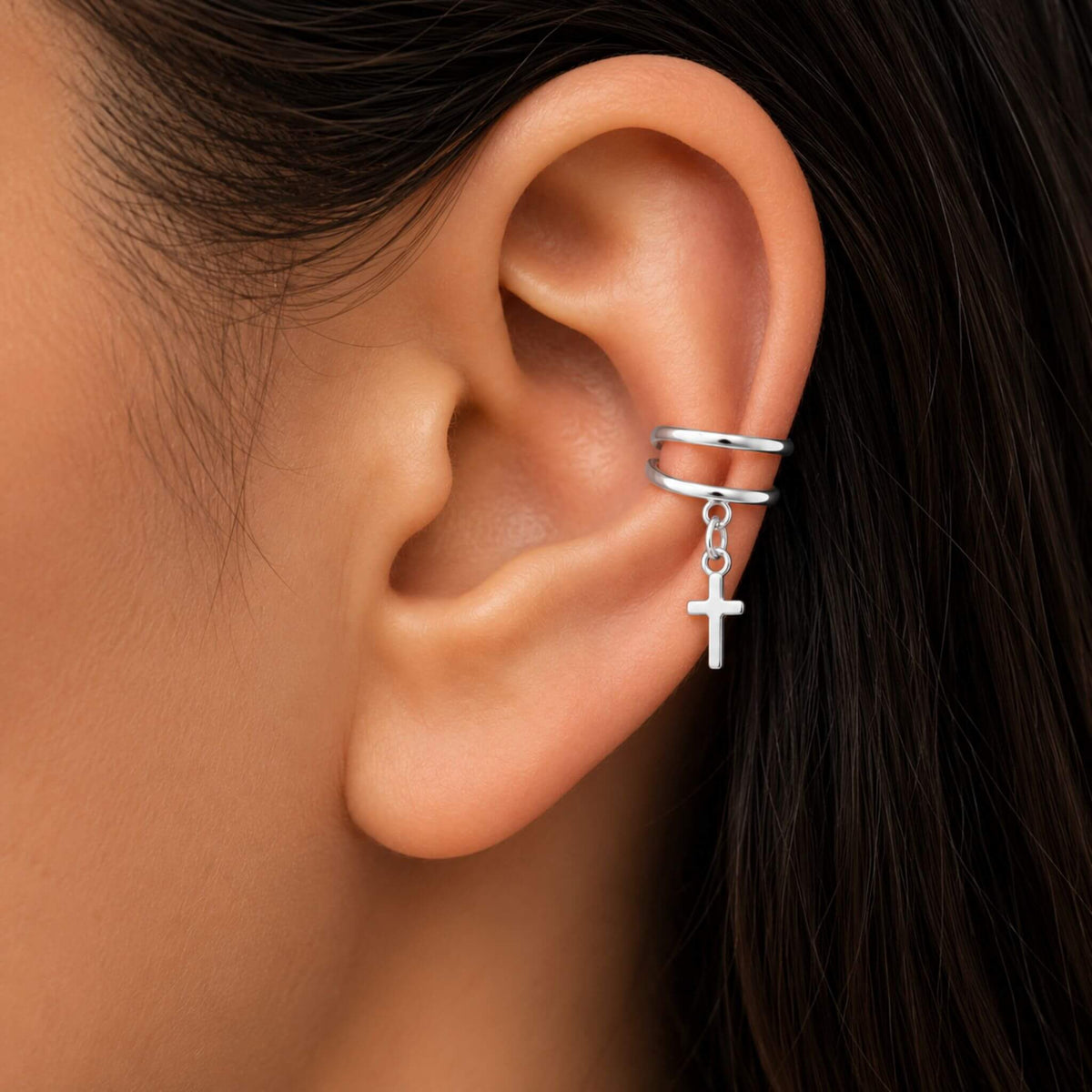 Model wearing 925 sterling silver cross ear cuff earrings with dangling cross charm, no piercing required.