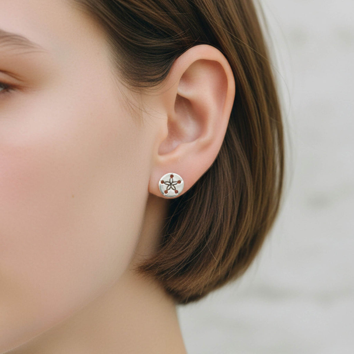 925 sterling silver sand dollar stud earrings worn on ear, coastal nautical stud earrings