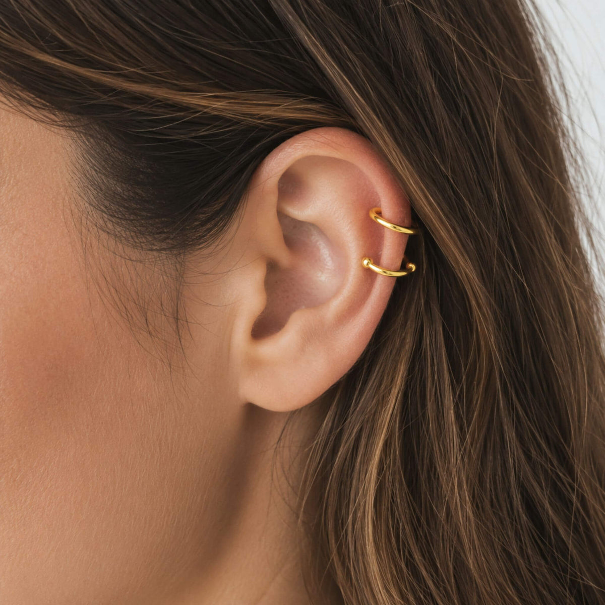 Close-up of a model wearing the gold Double Loop Ear Cuff with no piercing required, showing a minimalist double band design for everyday wear.