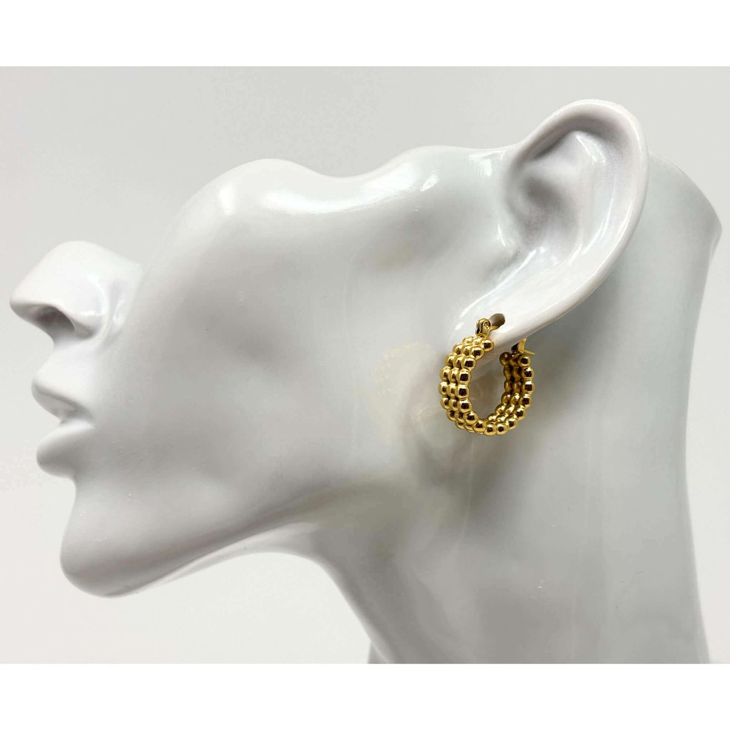 Fashionable 18K gold hoop earrings featuring triple beads, ideal for sophisticated looks.