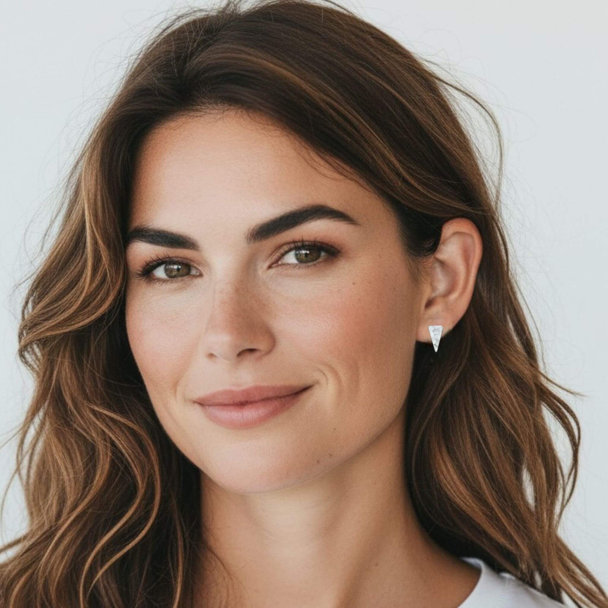 Minimalist elongated hammered triangle stud earrings in sterling silver worn by model