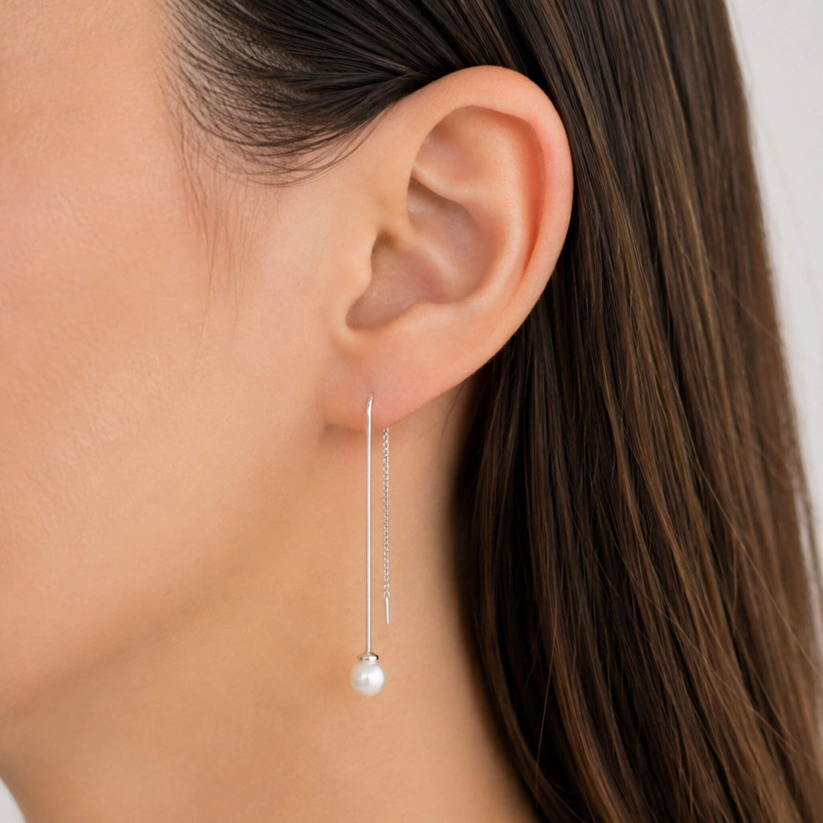 Freshwater pearl threader earring in sterling silver worn on ear