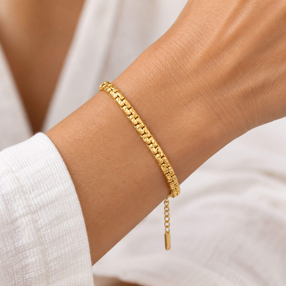 Gold chain bracelet for women worn on wrist showing textured link design and adjustable fit