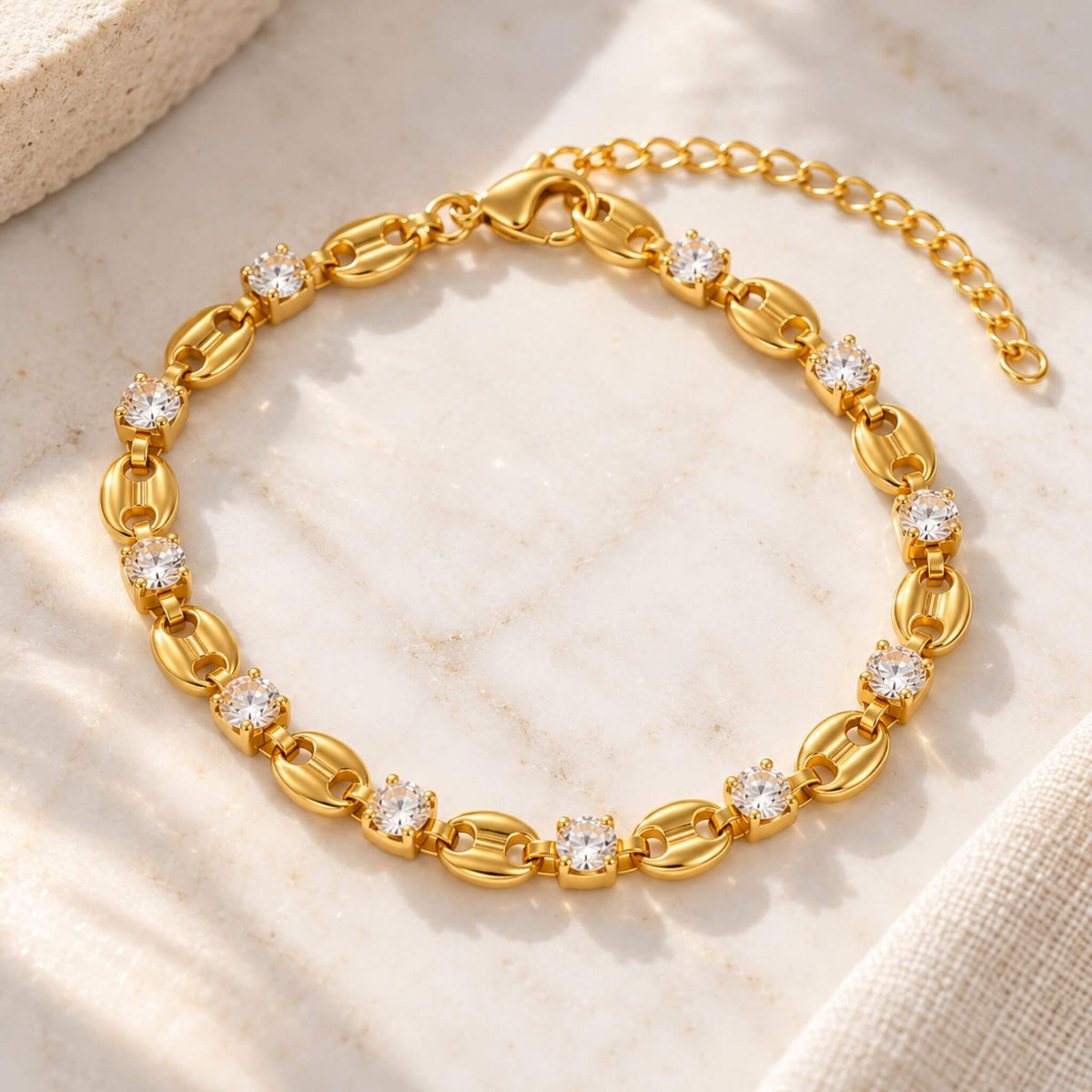Gold cubic zirconia link bracelet with 18K gold plated stainless steel finish and adjustable extender