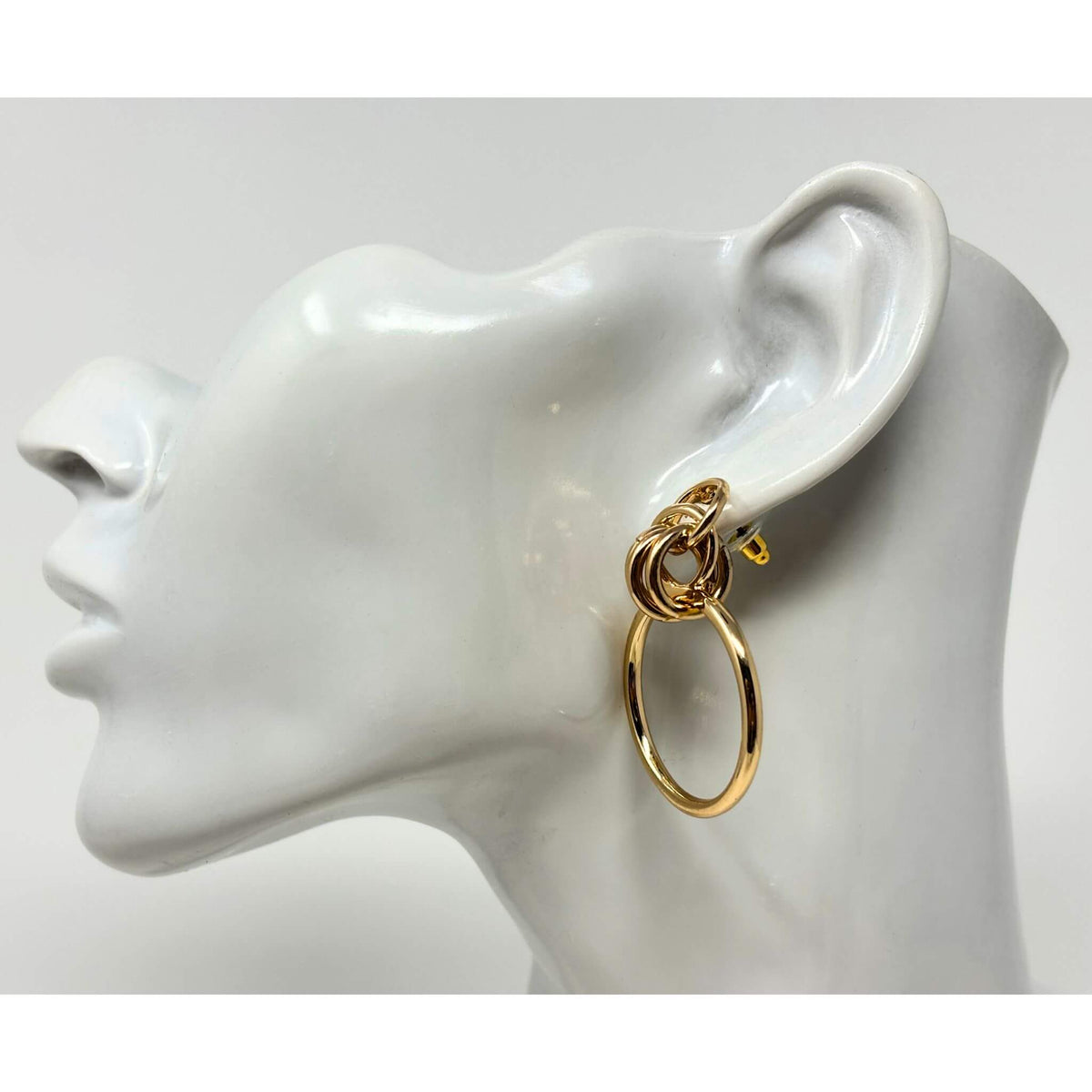 Side view of gold door knocker hoop stud earrings, featuring a bold layered hoop design, perfect for fashion jewelry.
