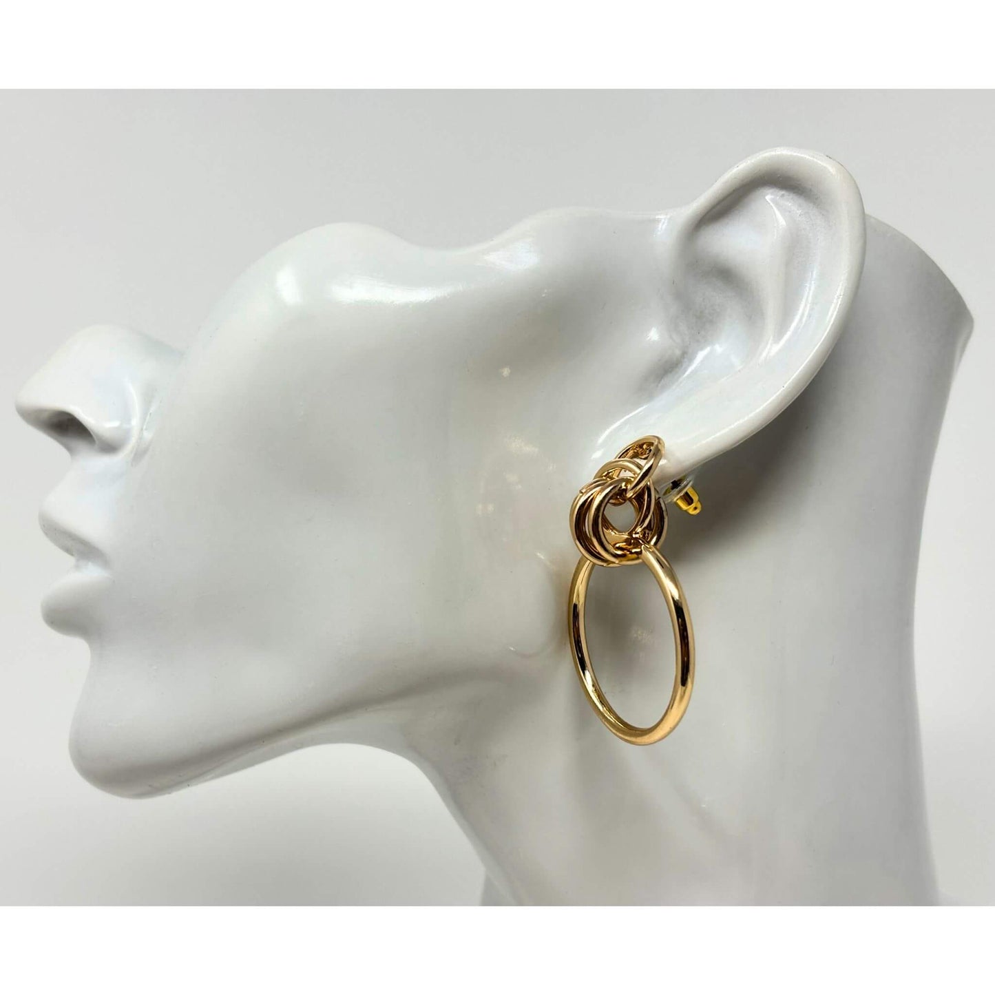 Side view of gold door knocker hoop stud earrings, featuring a bold layered hoop design, perfect for fashion jewelry.