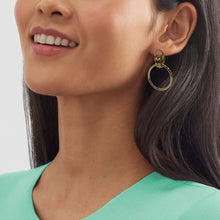 Model wearing geometric multi-circle gold hoop stud earrings, perfect for modern fashion and elegant jewelry looks.
