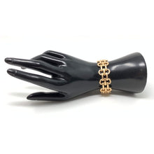 Gold link cuff stretch bracelet that can be stacked with other bracelets.
