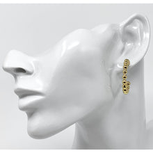 Statement gold hoop earrings with delicate beaded design.
