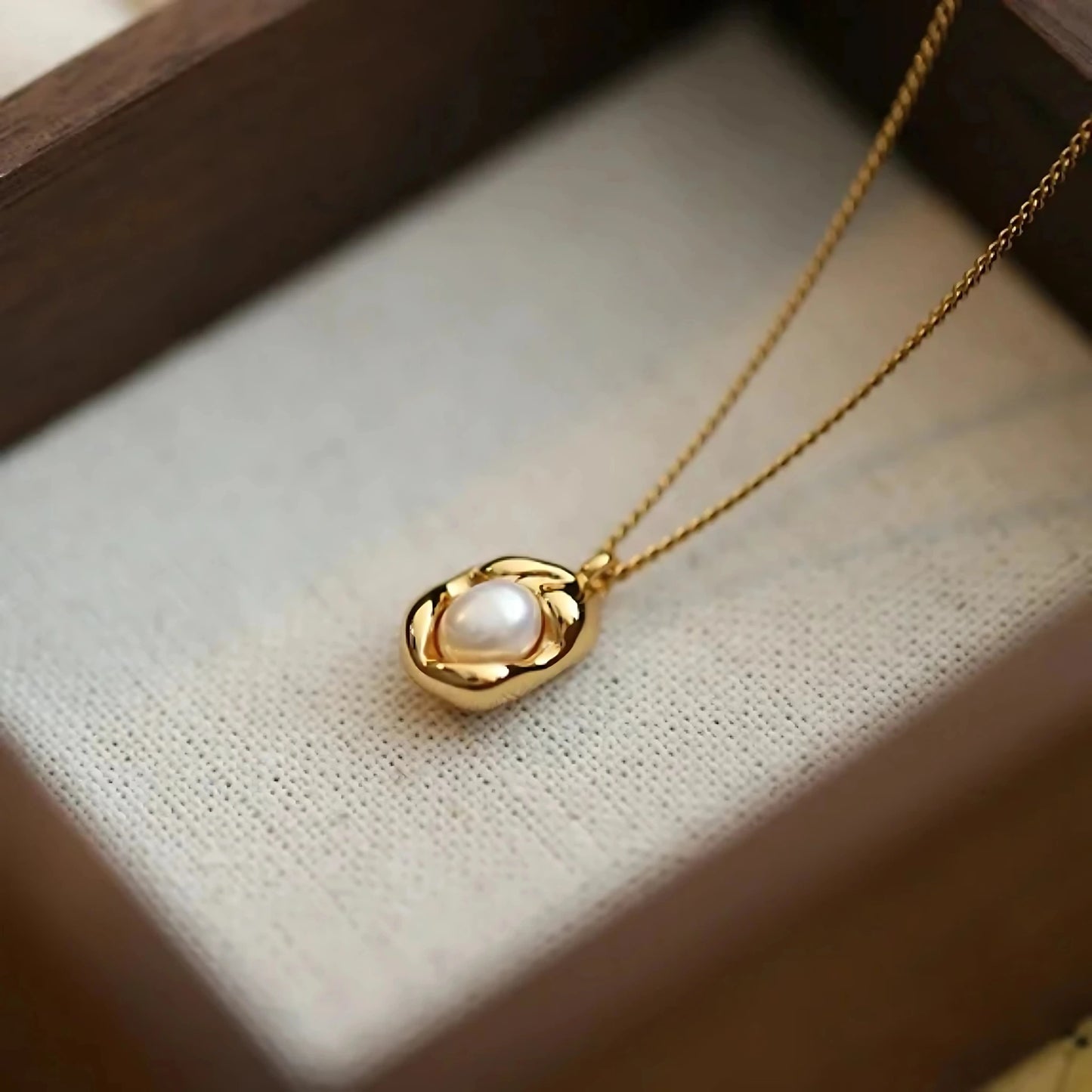 Hypoallergenic gold-plated necklace featuring freshwater pearl and gold nugget charm