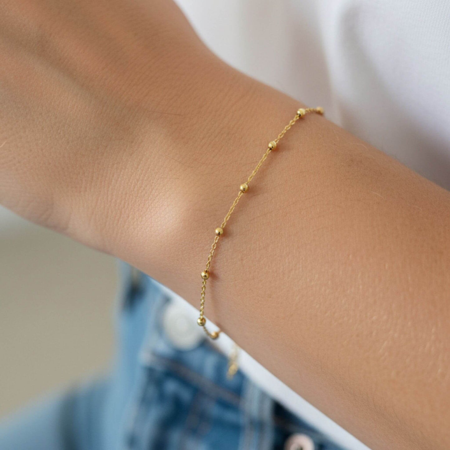 Minimalist 18K gold plated ball bracelet styled for everyday wear