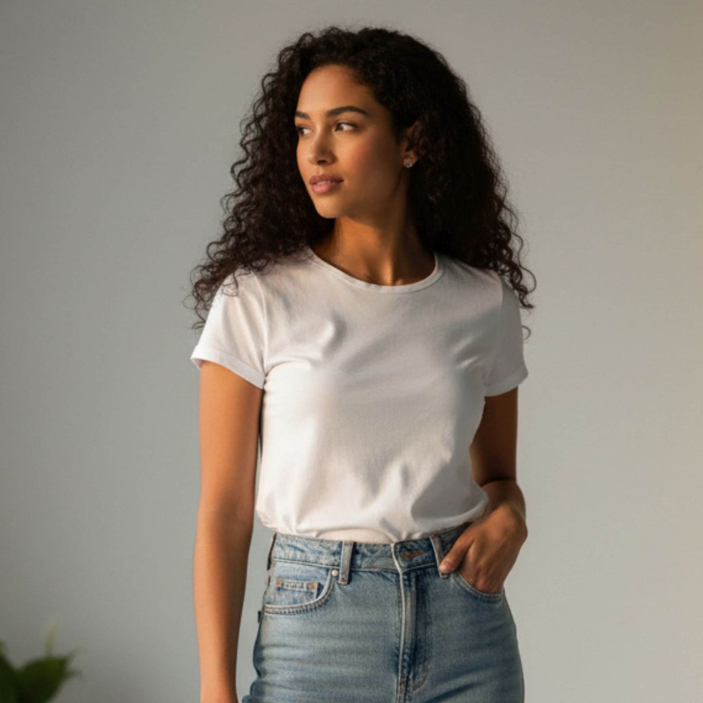 Woman wearing minimalist sterling silver circle and bar stud earrings