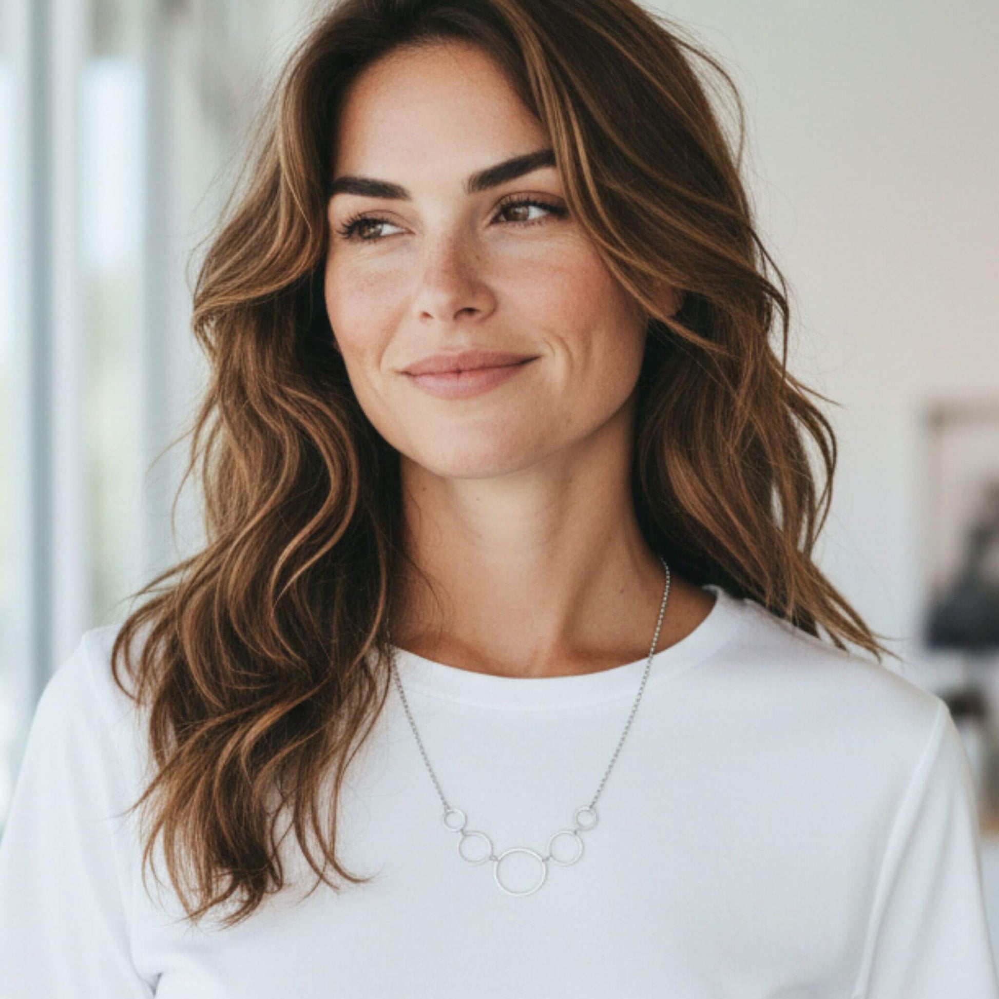 Minimalist sterling silver interlocking circle necklace styled for everyday wear