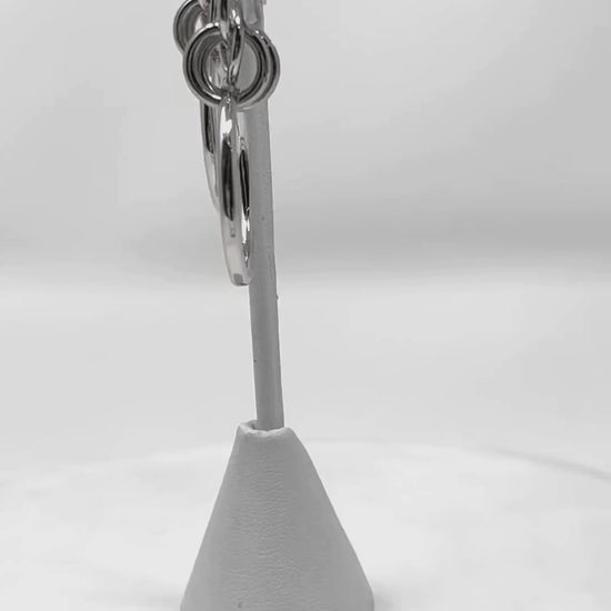 Video featuring geometric multi-circle silver hoop stud earrings, presenting a sleek and stylish accessory for any fashion-forward outfit