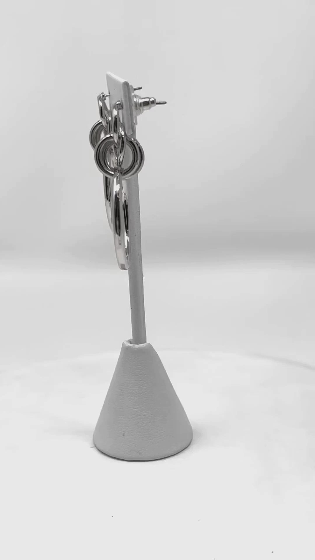 Video featuring geometric multi-circle silver hoop stud earrings, presenting a sleek and stylish accessory for any fashion-forward outfit