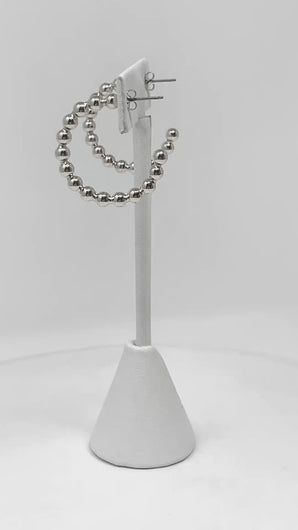 Ball beaded hoop earrings add a touch of sophistication to any occasion.