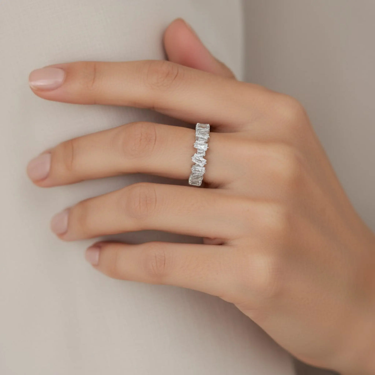 Model wearing silver 5A cubic zirconia open ring on hand showing elegant rectangular stones and adjustable design