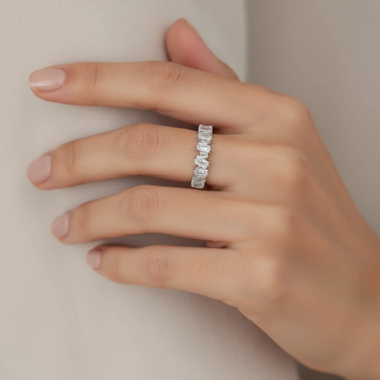 Model wearing silver 5A cubic zirconia open ring on hand showing elegant rectangular stones and adjustable design