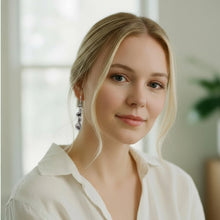 Blonde woman wearing silver modern wave dangle earrings – lightweight sculptural drop design by SeaSpray Jewelry
