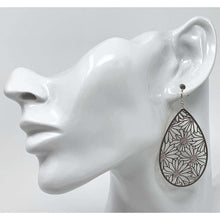 Silver Daisy Teardrop Earrings adding elegance to a formal outfit.
