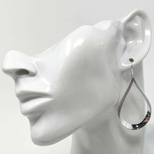 Silver Teardrop Earrings With A Dangling Design
