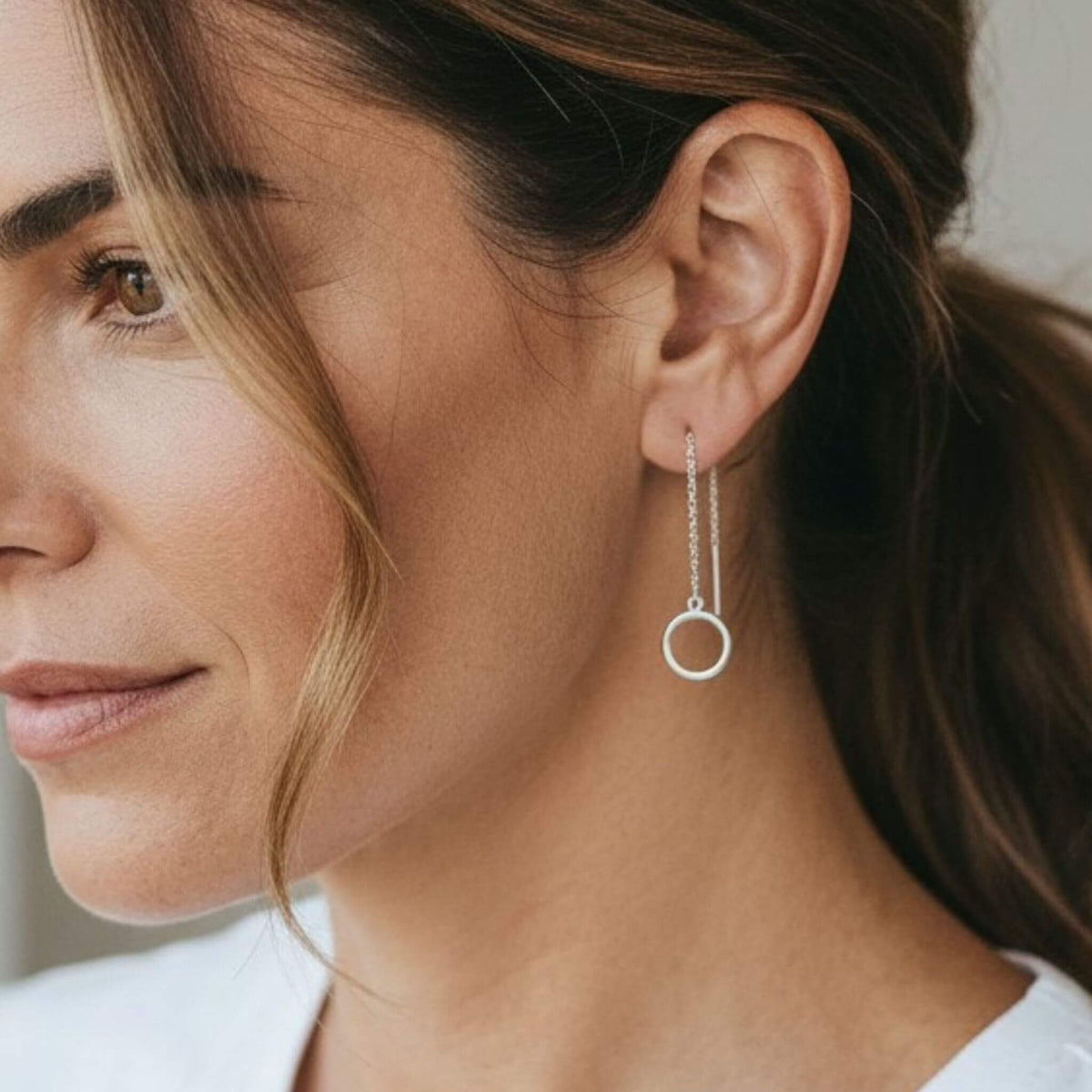 Sterling silver open circle threader earrings worn on model with ponytail — minimalist dangle earrings