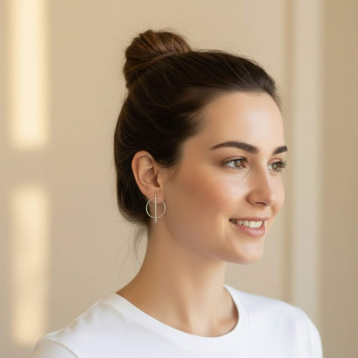 Sterling silver geometric bar and circle stud earrings on model with bun updo, side view showing full 33mm earring silhouette, minimalist everyday style