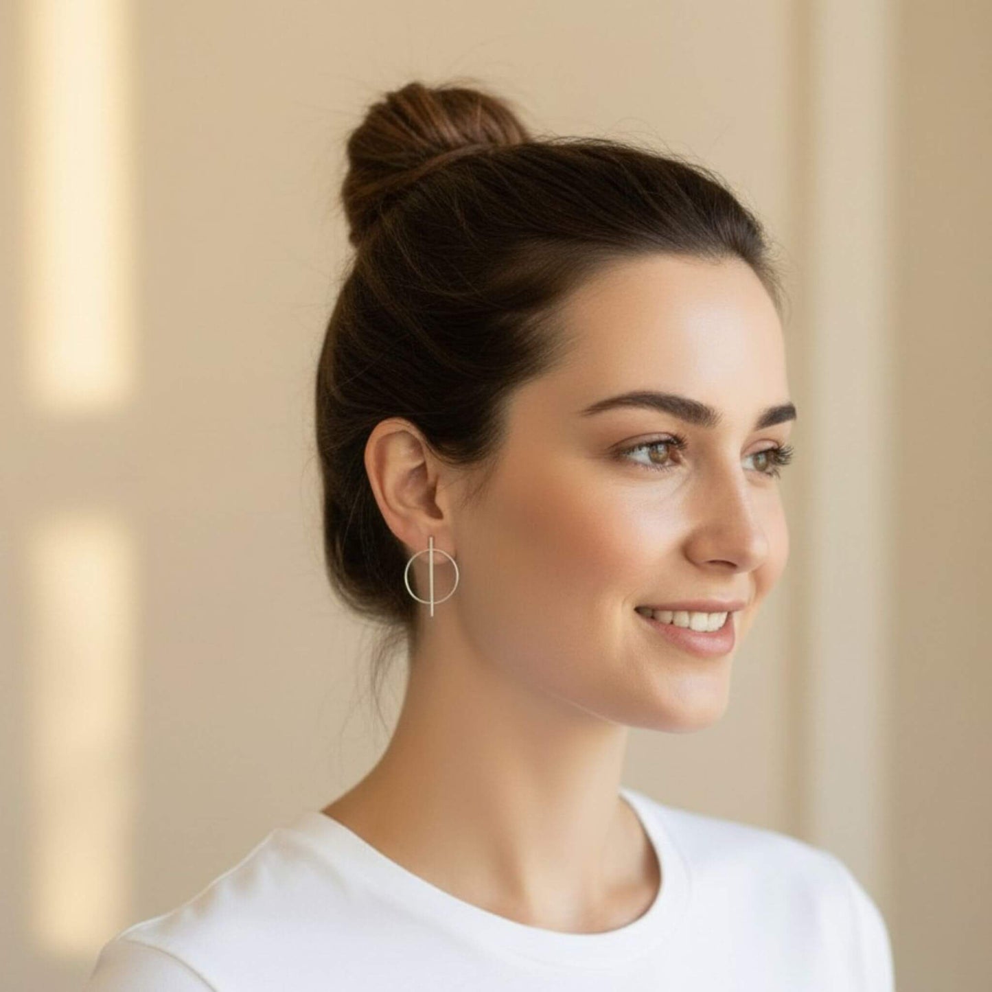 Sterling silver geometric bar and circle stud earrings on model with bun updo, side view showing full 33mm earring silhouette, minimalist everyday style