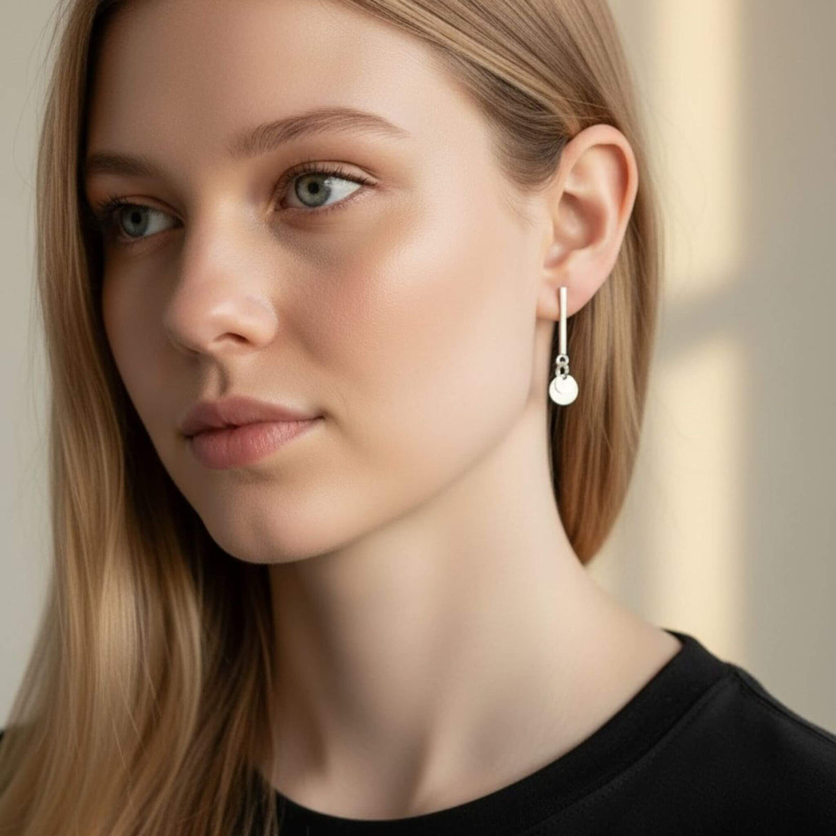 Sterling silver vertical bar and circle disc drop stud earrings worn by model, side profile showing 26mm drop length below earlobe