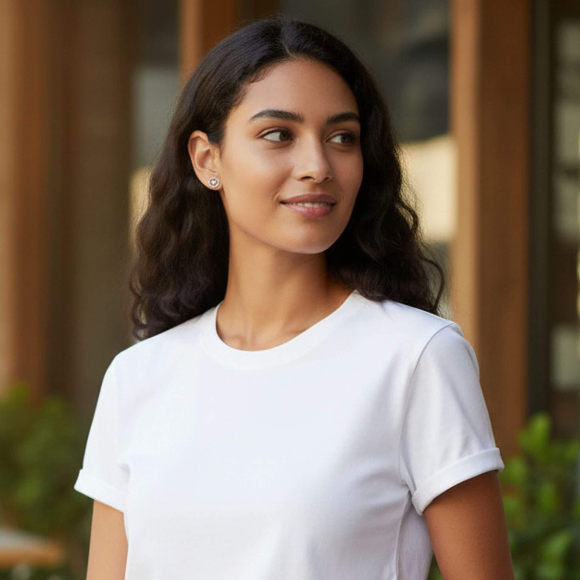 Woman wearing sterling silver compass stud earrings