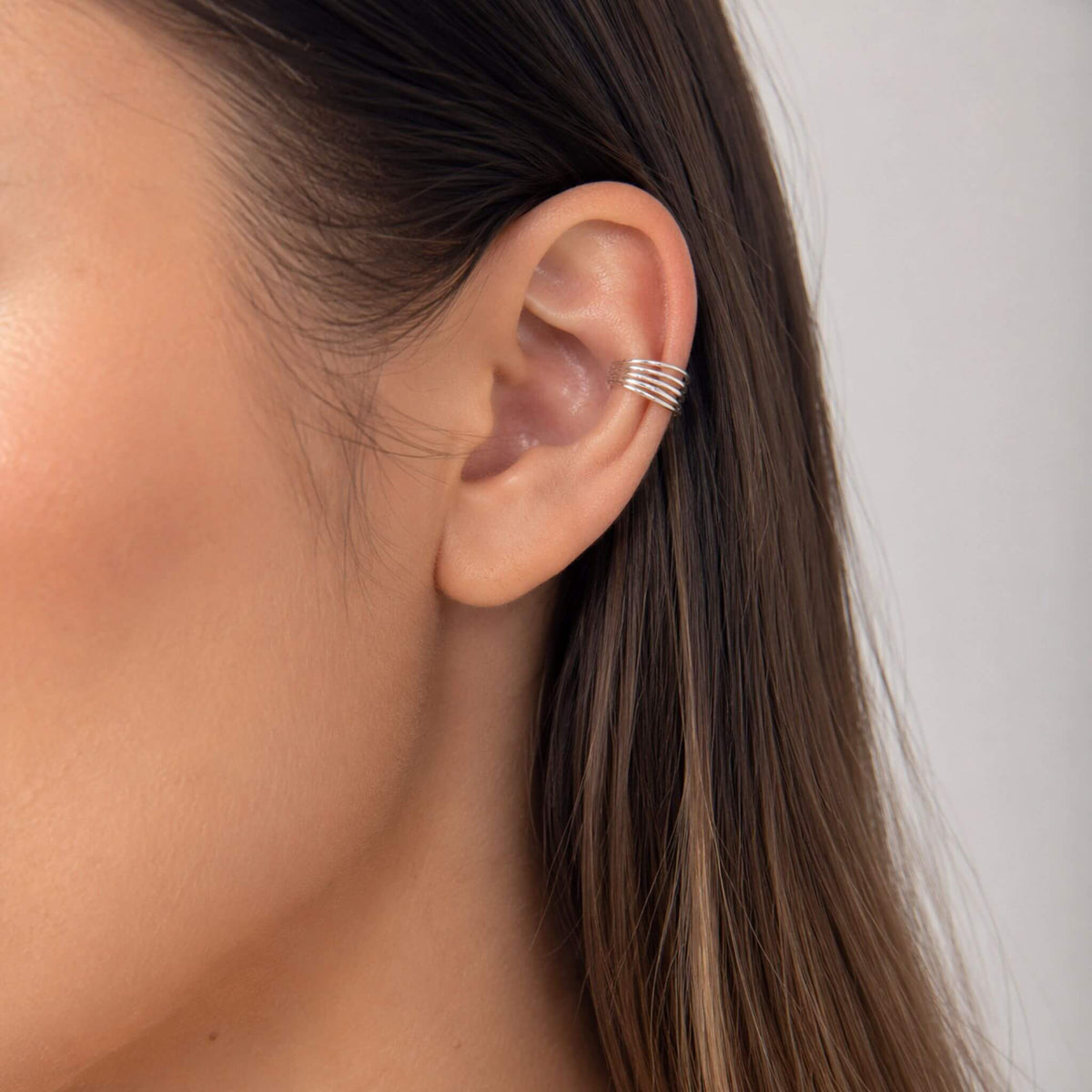 Sterling silver five band ear cuff worn on cartilage — hypoallergenic, no piercing needed