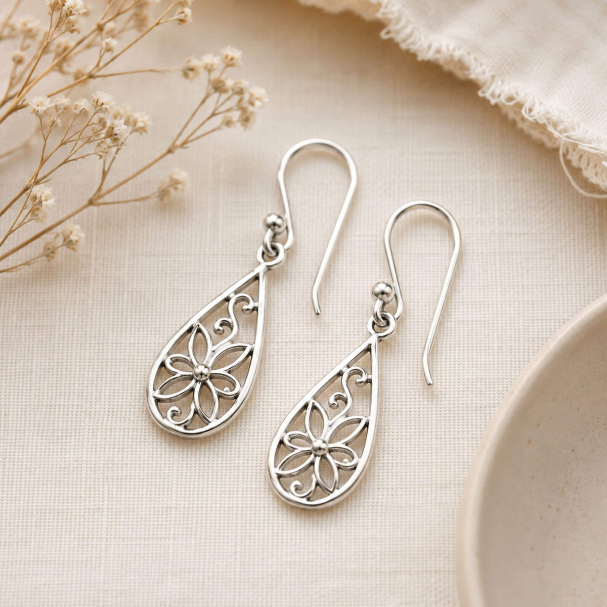 Sterling silver floral dangle earrings with open flower teardrop design