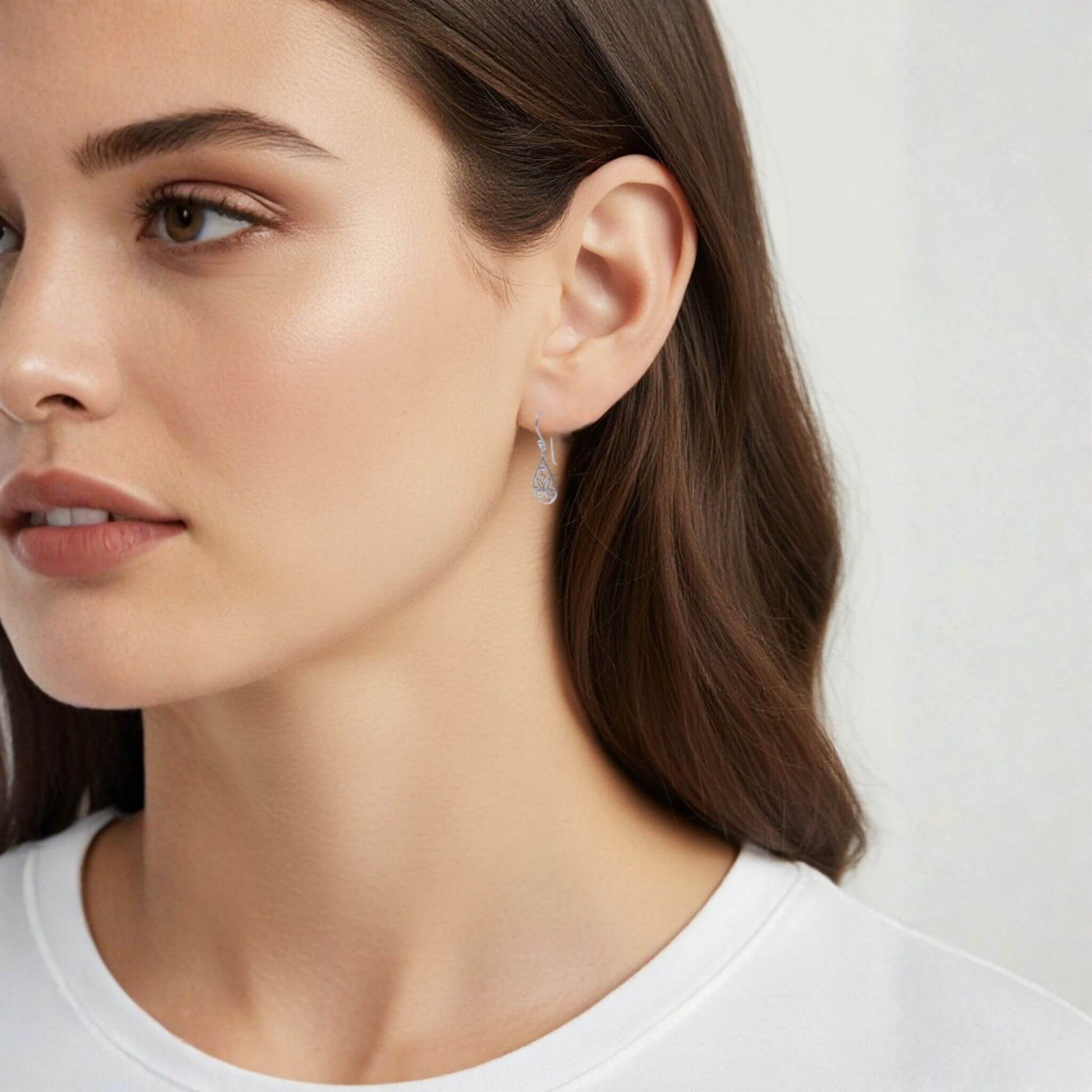 Sterling silver floral drop earrings worn on model lifestyle view