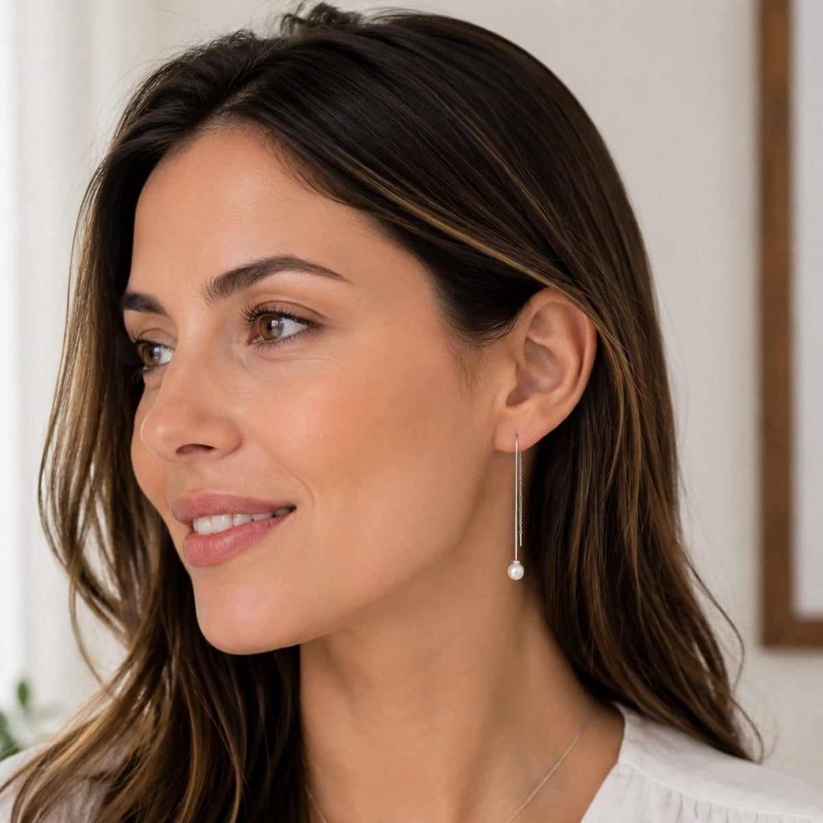 Sterling silver freshwater pearl drop threader earrings worn by woman