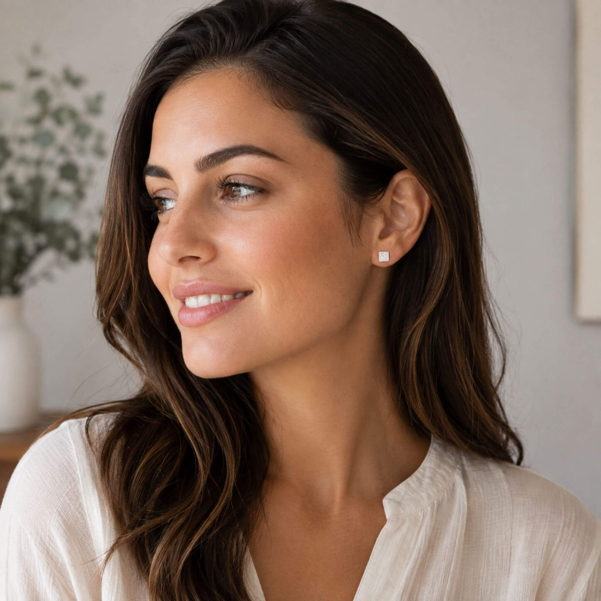 Woman wearing small sterling silver square stud earrings