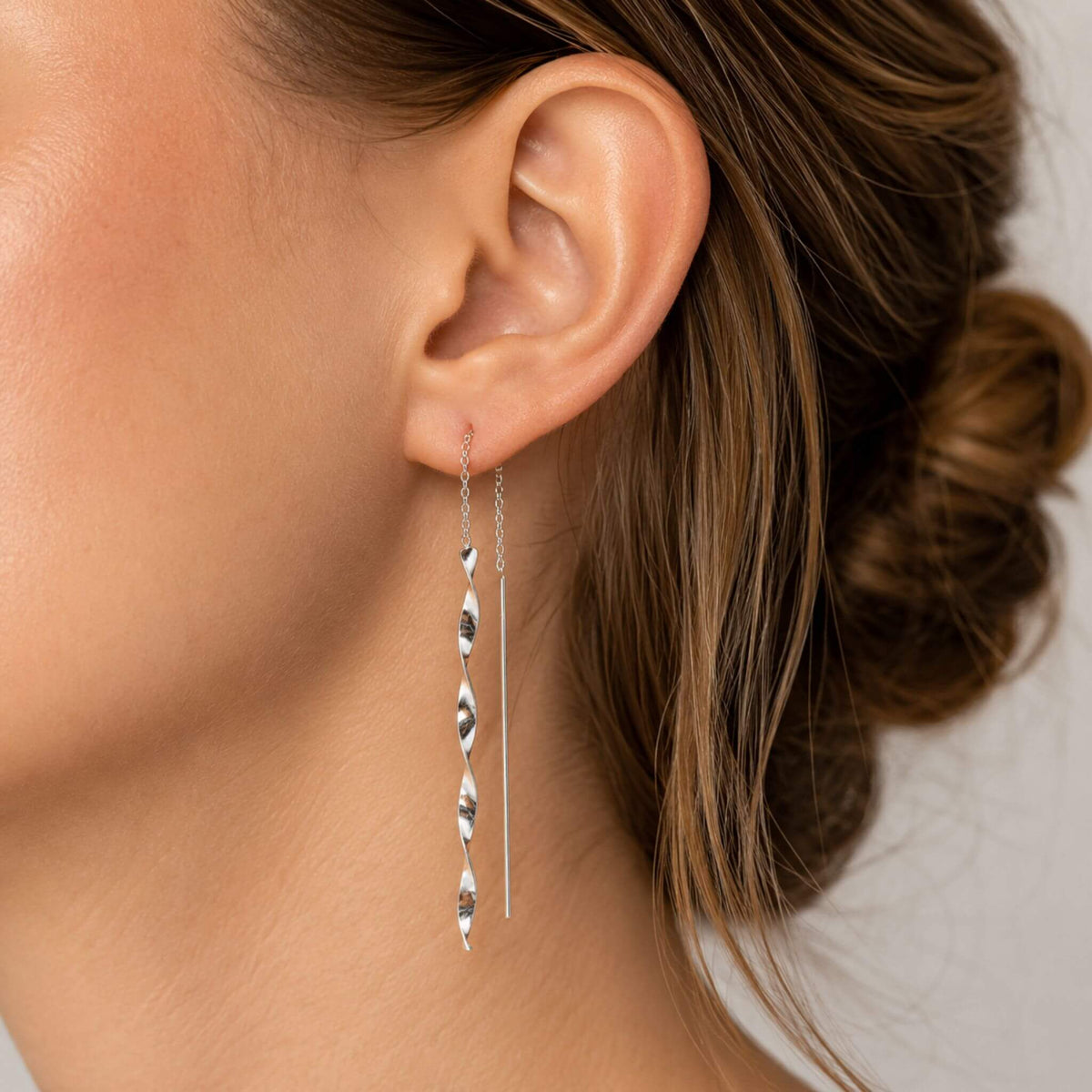 Model wearing long sterling silver spiral twist threader earrings