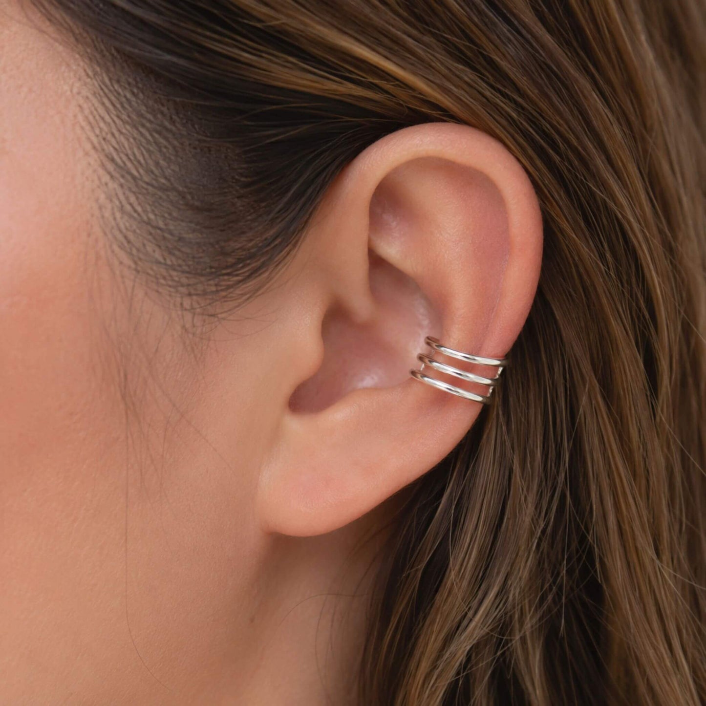 Woman wearing a Triple Band Sterling Silver Ear Cuff, adjustable no piercing minimalist silver ear cuff for cartilage.