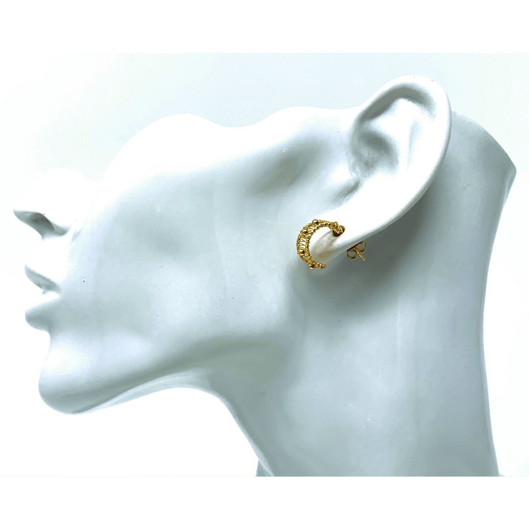 Pair of hypoallergenic sterling silver half hoop earrings with gold finish, styled for everyday wear