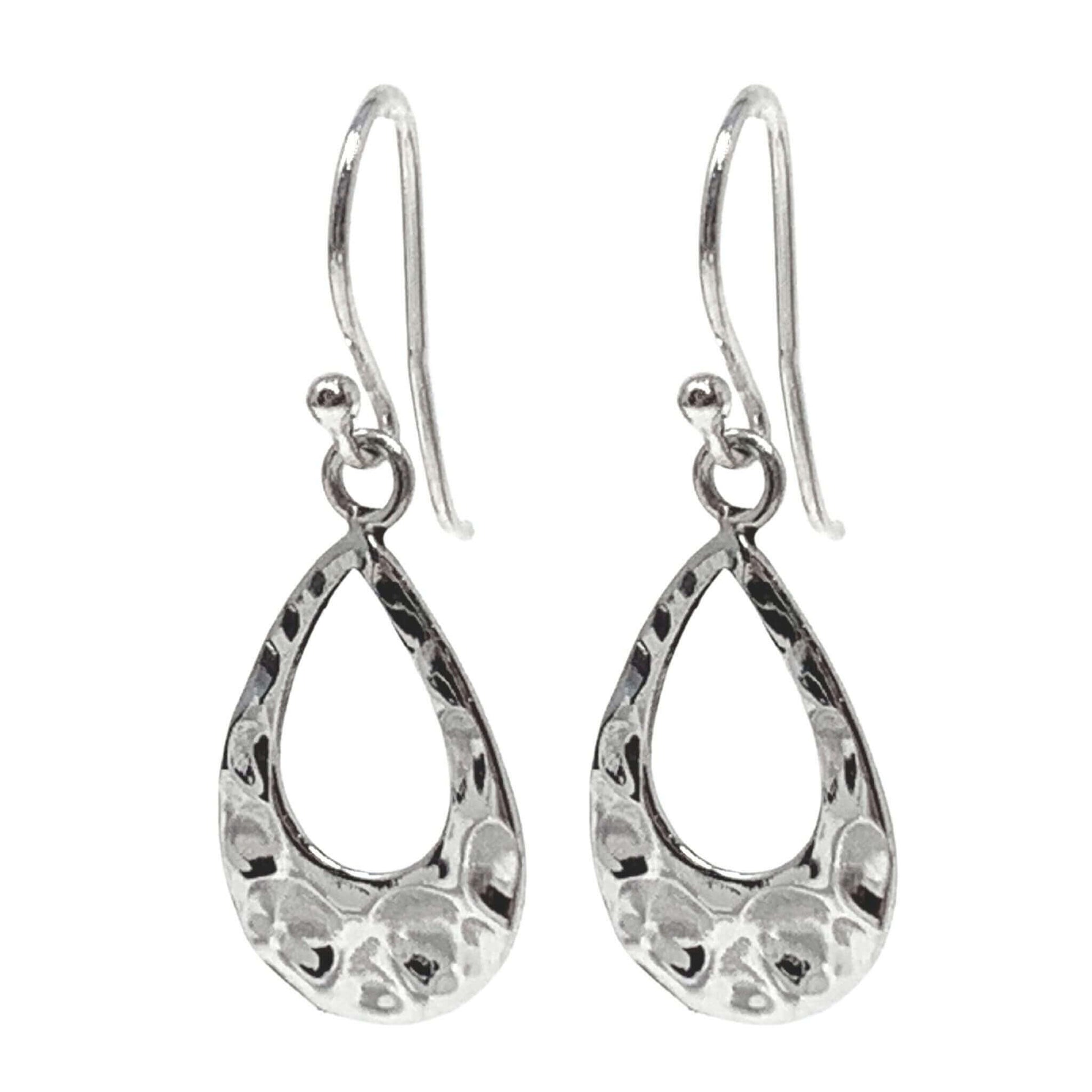 Dainty sterling silver teardrop earrings complement a relaxed, everyday style.