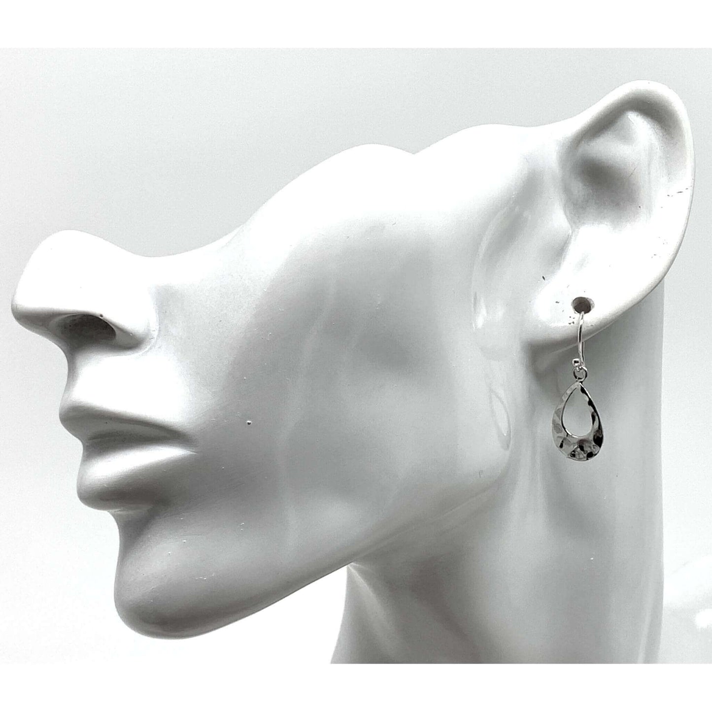 Dainty sterling silver teardrop earrings add elegance to a professional work look.