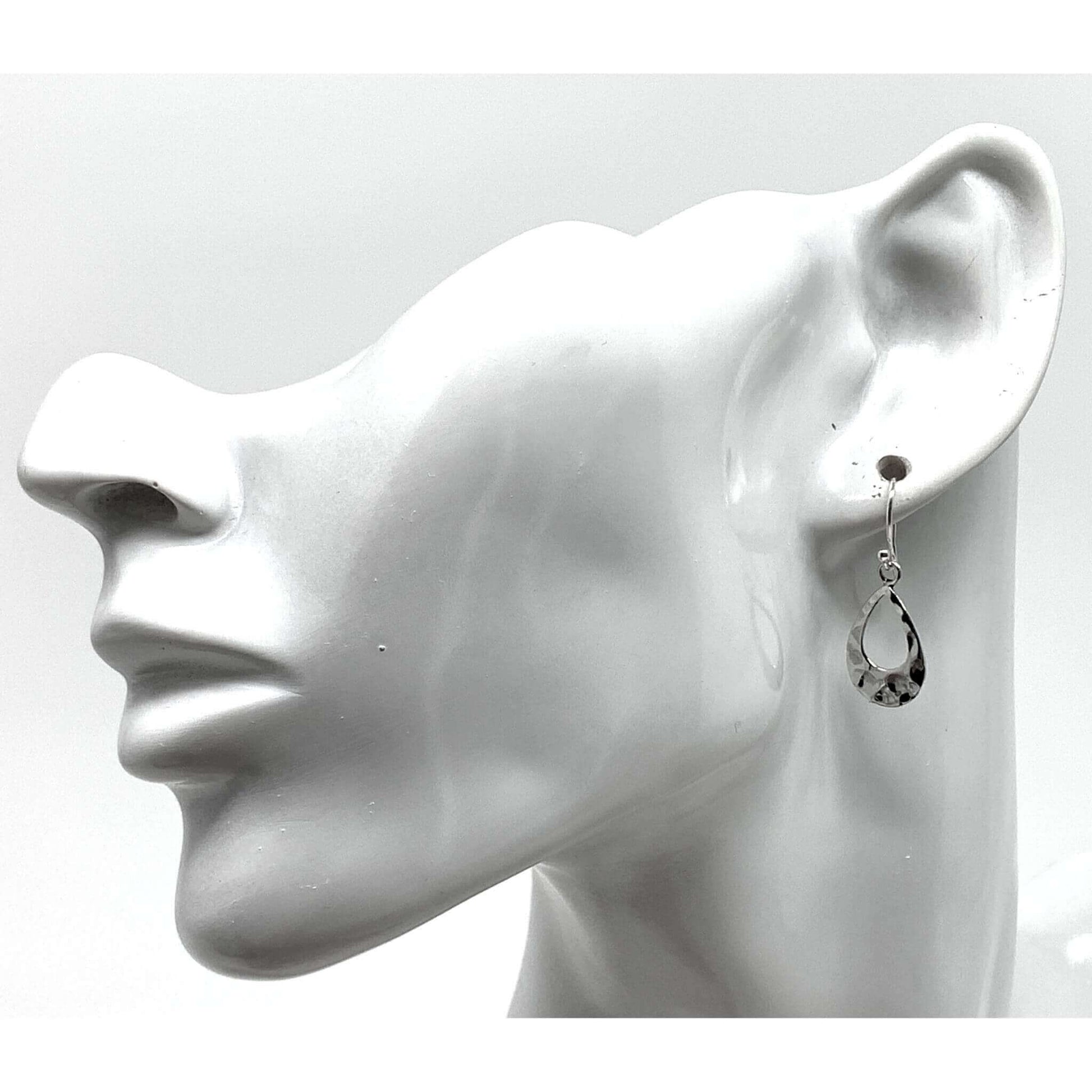 Dainty sterling silver teardrop earrings add elegance to a professional work look.